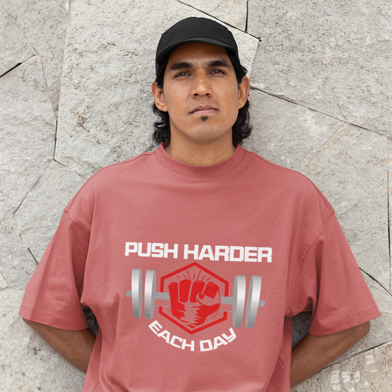 Push Harder Each Day Gym Graphic Unisex T-Shirt – Red Fist and Barbell Design in Coral
