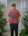 Model wearing coral oversized unisex t-shirt with "American Rider" graphic – Thodacrazyclub
