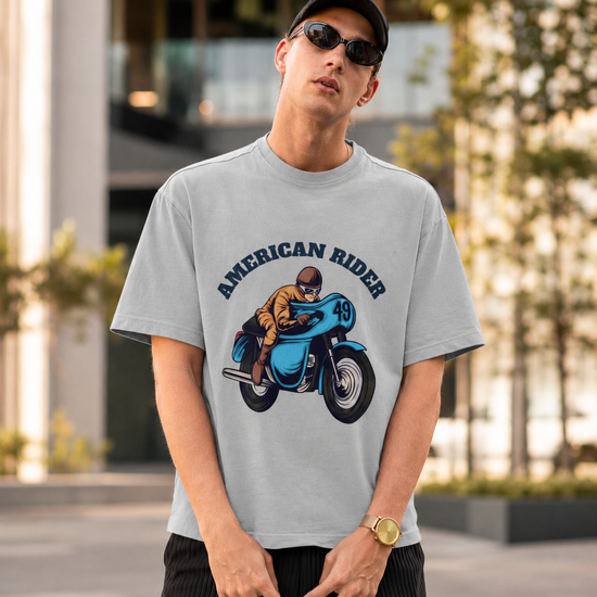 Model wearing grey melange oversized unisex t-shirt with "American Rider" graphic – Thodacrazyclub