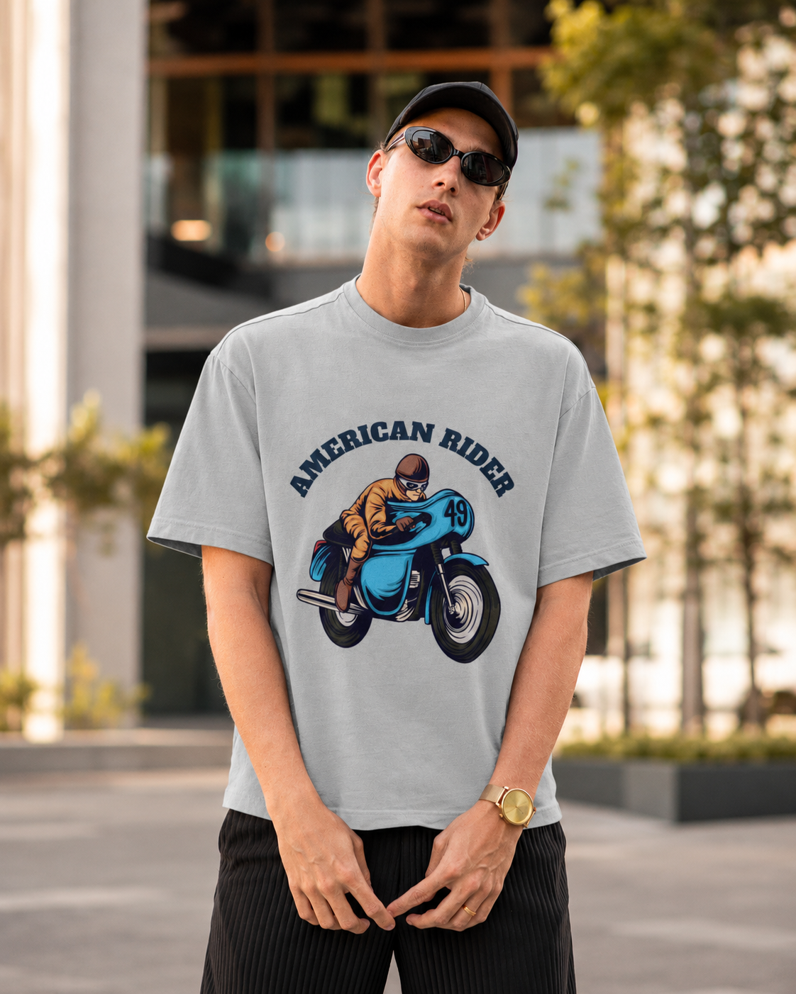Model wearing grey melange oversized unisex t-shirt with "American Rider" graphic – Thodacrazyclub