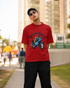 Model wearing red oversized unisex t-shirt with "American Rider" graphic – Thodacrazyclub